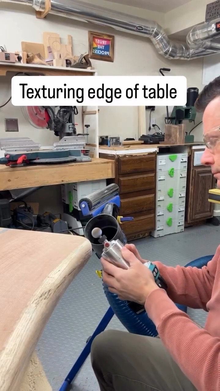 A woodworker texturing the edge of a table with a Kutzall burr