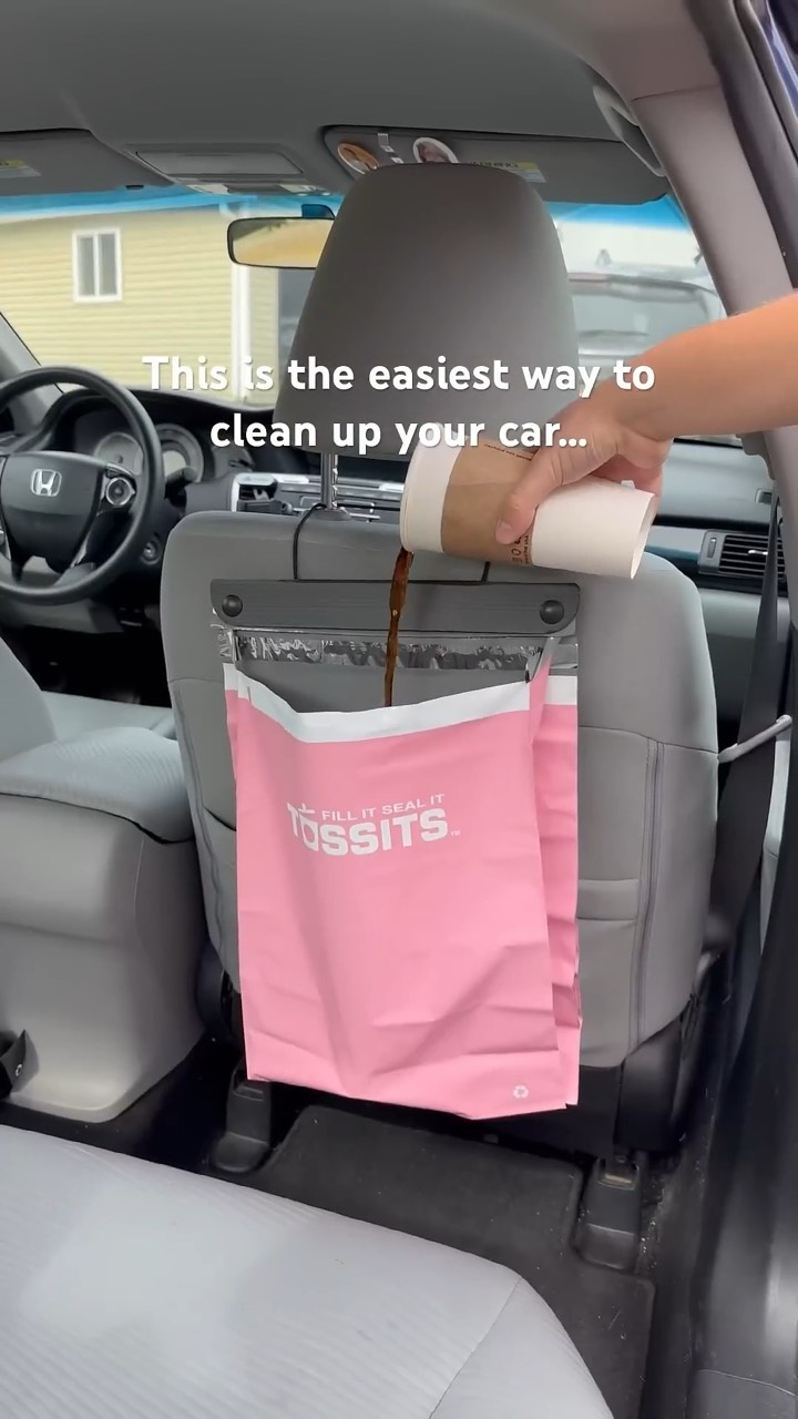 Coffee poured into a pink Tossits bag hanging from a car seat